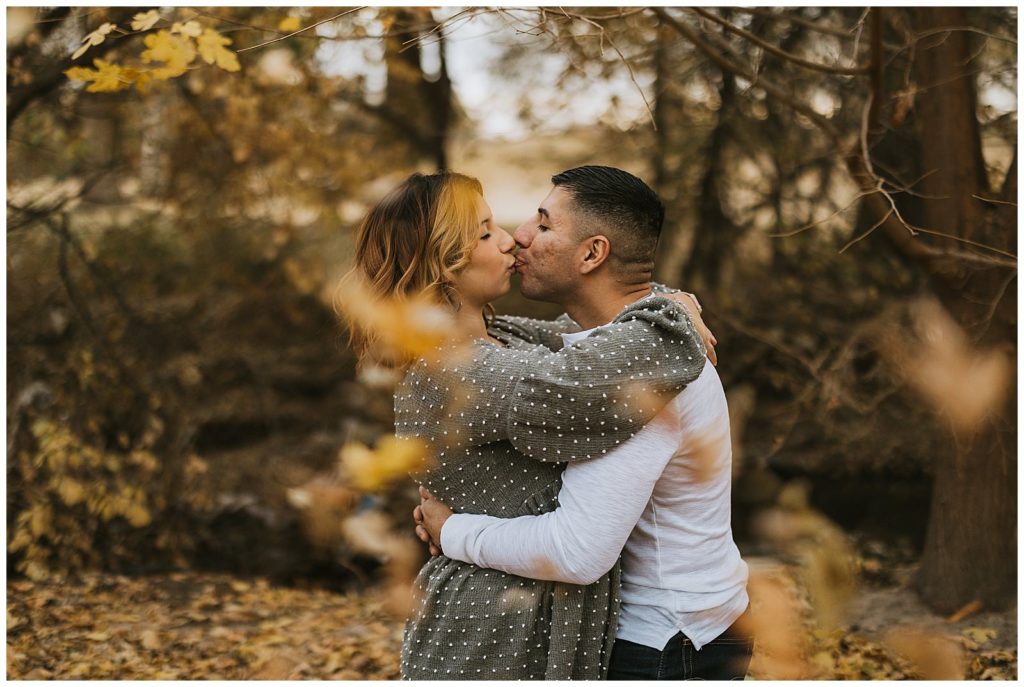 leaves falling around an engaged couple during their lubbock texas engagement session
